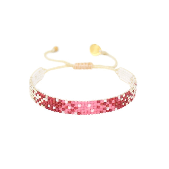 Delicate design inspired by the beauty and passion of the Amazon forest! This spectacular play of whites, pinks and reds makes it an eye-catching accessory that can be worn alone or stacked, available in two different widths. To complete the look, match with our Mystic Heart Earrings! *Materials: Japanese Beads, polyester thread, gold-plated Logo